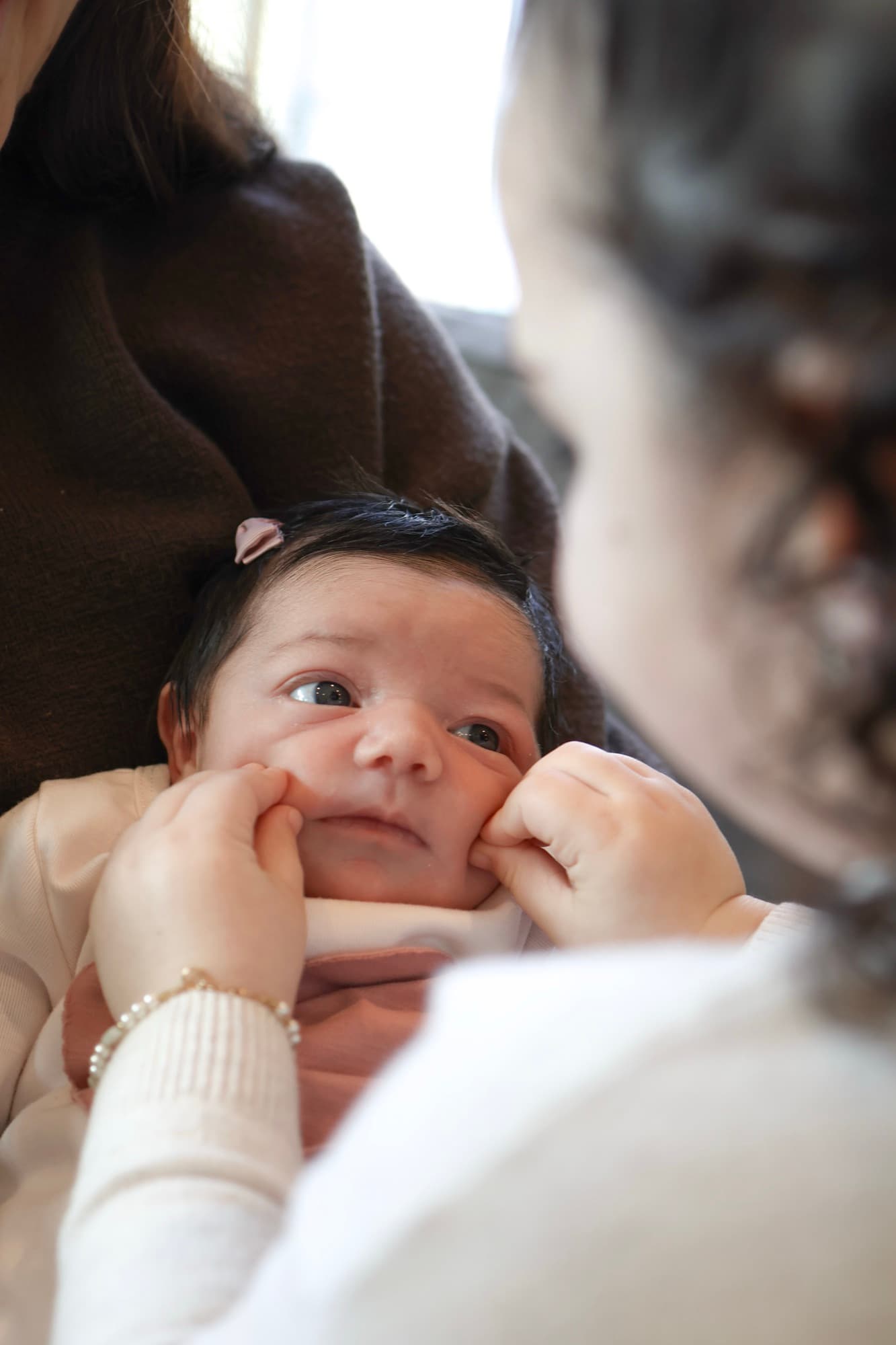 Newborn baby looking up at camera — candid baby portrait