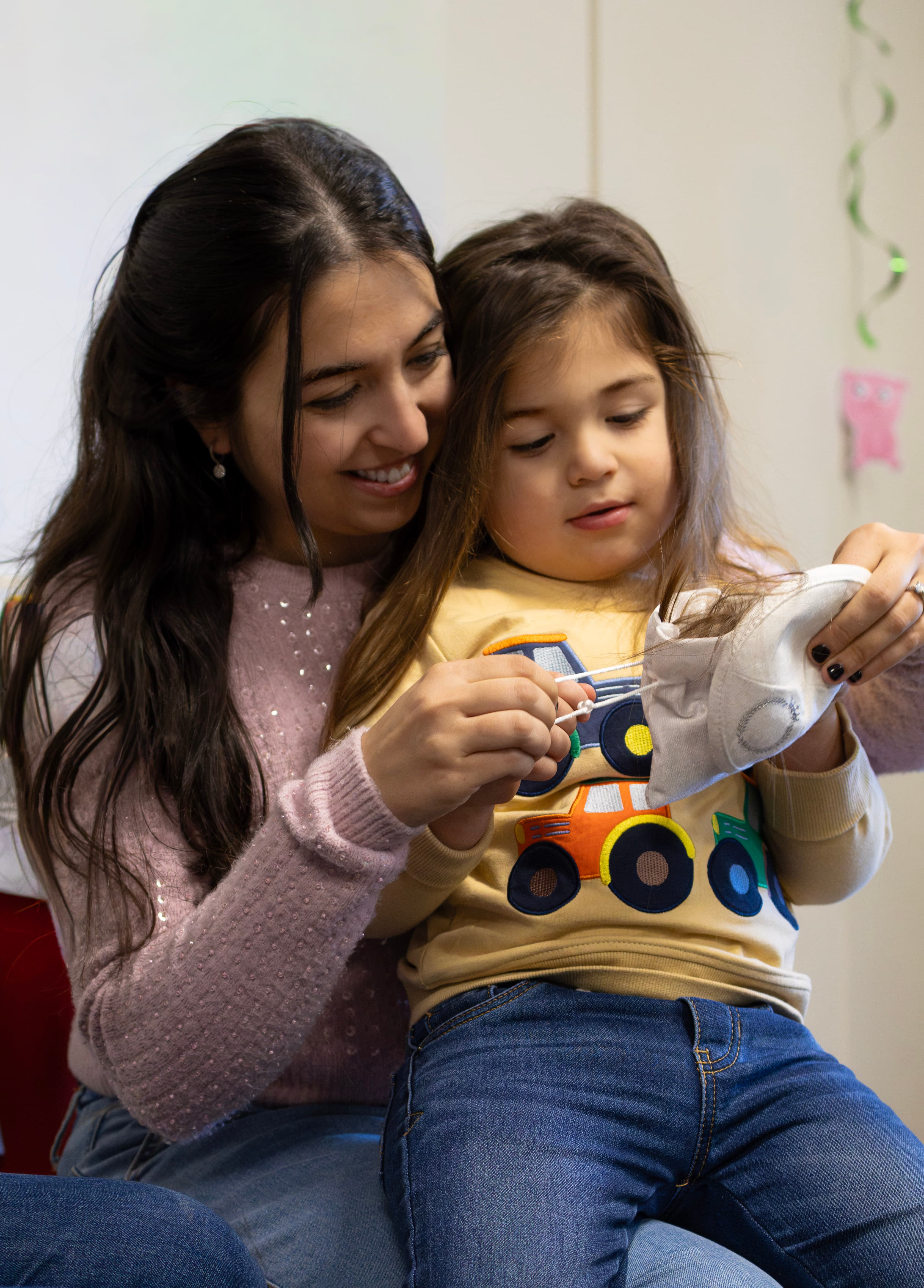 Grandmother holding the first lock of cut hair — Upshirin ceremony detail
